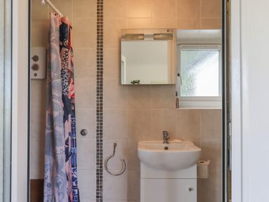 A bathroom with a shower and sink at The Old Telephone Exchange in Exeter