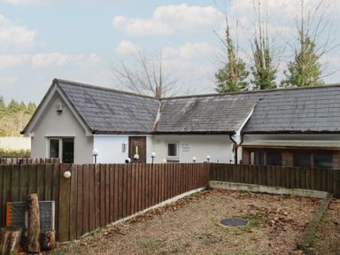 A house with a gravel yard and wooden fence at The Old Telephone Exchange in Exeter