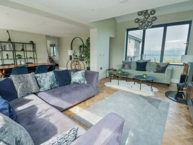 A living room with a sofa and coffee table at Pengarnedd in Amlwch