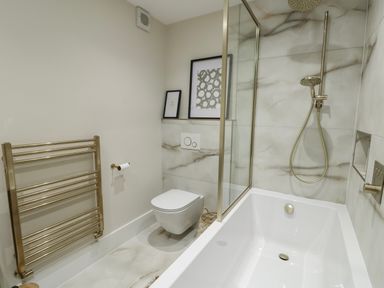 A bathroom with a bathtub and shower at Pengarnedd in Amlwch
