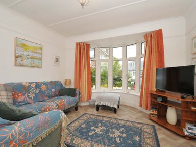 A living room with a sofa and television at Porthmeor in Wadebridge