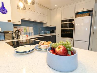 A kitchen with a fruit bowl and kitchen appliances at Still Waters in Weymouth