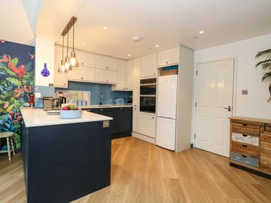 A kitchen with a refrigerator and oven at Still Waters in Weymouth