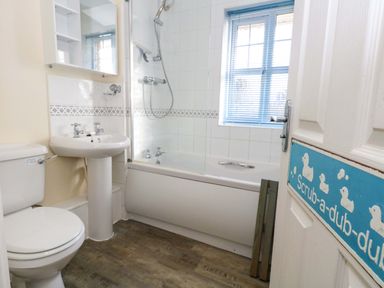 A bathroom with a bathtub and shower at Still Waters in Weymouth