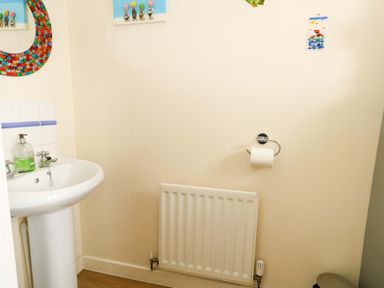A bathroom featuring a sink and a radiator at Still Waters in Weymouth