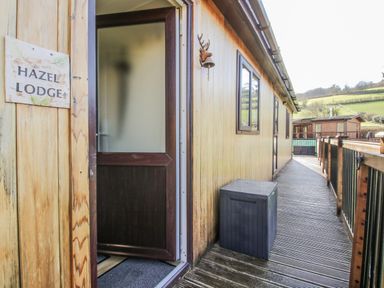 An entrance area of Hazel Lodge in Clunton near Clun with a wooden door and walkway
