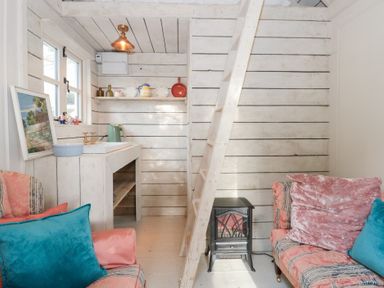 A living room with a staircase and a sink at Shades Farm Cabin in Circenester