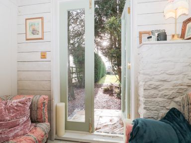 A view through an open door from the living room at Shades Farm Cabin in Cirencester