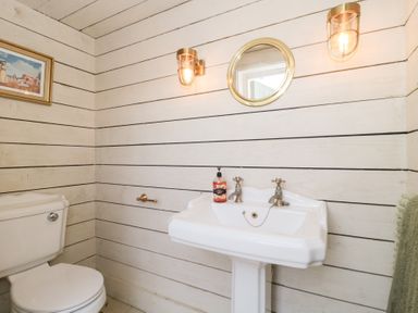 A bathroom with a sink and toilet at Shades Farm Cabin in Circenester