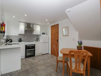 A kitchen with appliances and a dining area at Horse Gin in Lydney