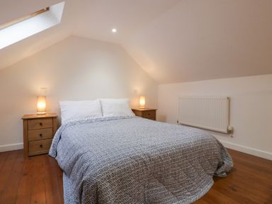 A bedroom with a bed and nightstands at Horse Gin in Lydney