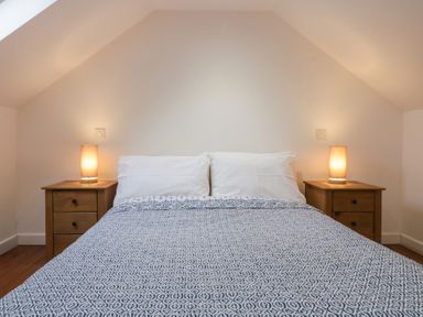 A bedroom with a bed and nightstands at Horse Gin in Lydney