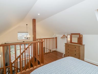 A bedroom with a bed and dressing table at Horse Gin in Lydney