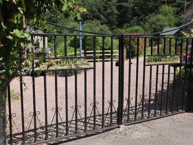 An outdoor entrance gate to a property with gravel pathway at Horse Gin in Parkend
