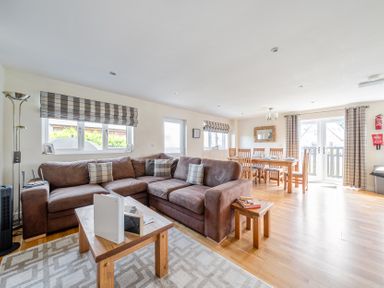 A living room with a sofa and dining area at James Ville Marina Lodge 7 Brigg