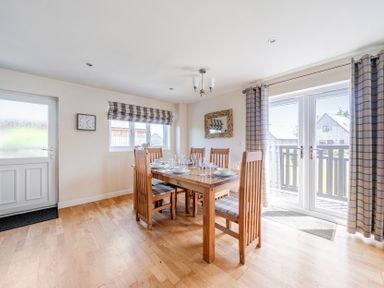 A dining room with a table and chairs at James Ville Marina Lodge 7 in Brigg