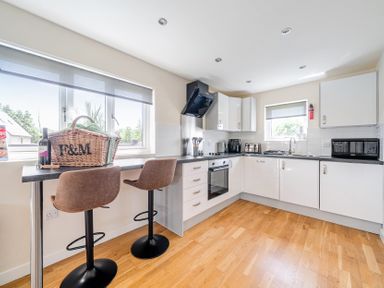 A kitchen with appliances and seating at James Ville Marina Lodge 7 in Brigg