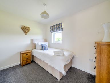 A bedroom with a single bed and bedside table at James Ville Marina Lodge 7 in Brigg