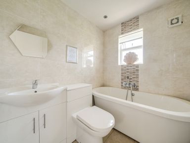 A bathroom with a bathtub and sink at James Ville Marina Lodge 7 in Brigg