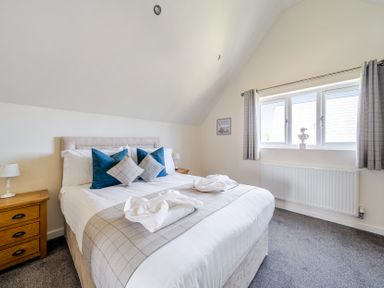 A bedroom with a bed and bedside table at James Ville Marina Lodge 7 in Brigg