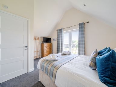 A bedroom with a bed and a dresser at James Ville Marina Lodge 7 in Brigg
