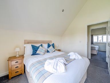 A bedroom with a bed and bedside table at James Ville Marina Lodge 7, Brigg