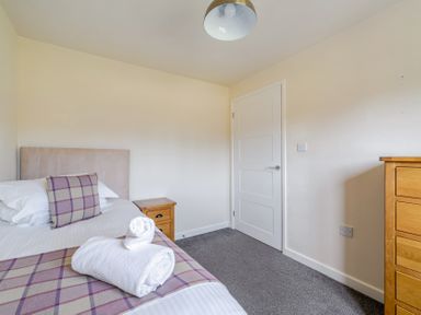 A bedroom with a bed and nightstand at James Ville Marina Lodge 8 in Brigg