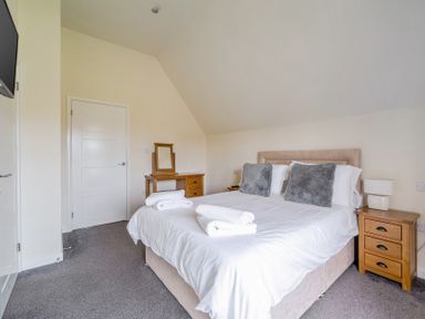 A bedroom with a bed and nightstand at James Ville Marina Lodge 8 in Brigg