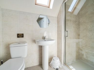 A bathroom with a toilet, sink, and shower at James Ville Marina Lodge 8 in Brigg