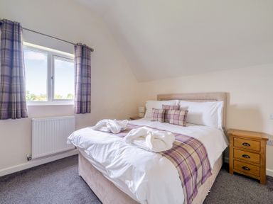 A bedroom with a bed and window at James Ville Marina Lodge 8 in Brigg