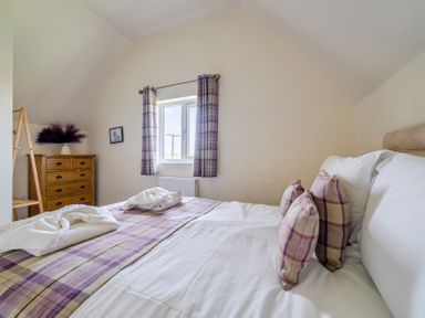 A bedroom with a bed and dresser at James Ville Marina Lodge 8 in Brigg
