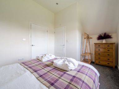 A bedroom with a bed and towels at James Ville Marina Lodge 8 in Brigg