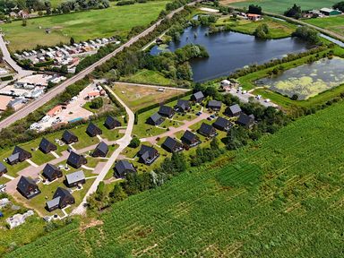 An aerial view of a housing area with houses and ponds at James Ville Marina Lodge 8 in Brigg