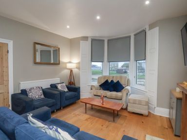 A living room with a sofa and coffee table at South Villa in Sandsend near Whitby