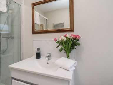 A bathroom with sink and mirror at South Villa Sandsend near Whitby