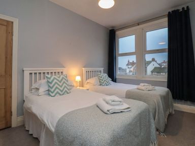 A bedroom with two single beds and a lamp at South Villa Sandsend near Whitby