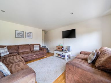 A living room with a sofa and television at James Ville Marina Lodge 9 in Brigg