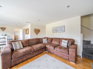 A living room with a sofa and dining area at James Ville Marina Lodge 9 in Brigg