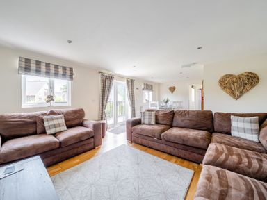 A living room with a sofa and dining area at James Ville Marina Lodge 9 in Brigg