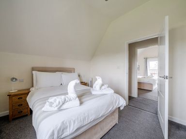 A bedroom with a bed and nightstand at James Ville Marina Lodge 9, Brigg