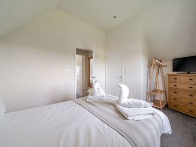 A bedroom with a bed and towels at James Ville Marina Lodge 9 Brigg