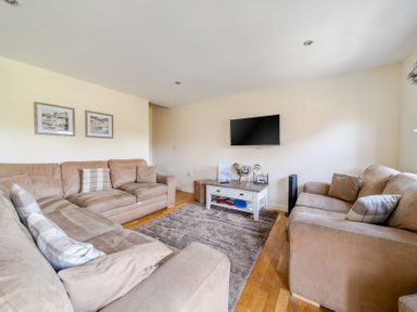 A living room with a television and two sofas at James Ville Marina Lodge 13 in Brigg