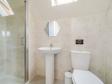 A bathroom with a shower, sink, and toilet at James Ville Marina Lodge 13 in Brigg
