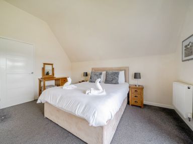 A bedroom with a bed and side table at James Ville Marina Lodge 13 in Brigg