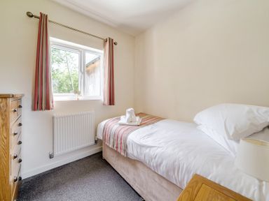 A bedroom with a bed and window at James Ville Marina Lodge 13 in Brigg