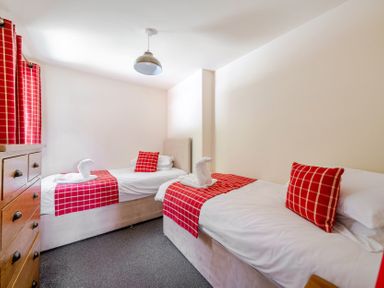 A bedroom with two beds and a chest of drawers at James Ville Marina Lodge 13 in Brigg