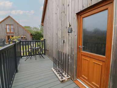 An outdoor area with a wooden door and seating at James Ville Marina Lodge 14, Brigg