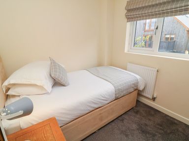 A bedroom with a single bed and window at James Ville Marina Lodge 14 in Brigg