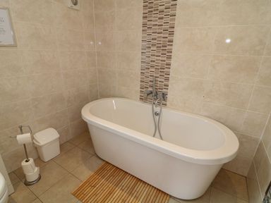 A bathroom with a bath tub and toilet at James Ville Marina Lodge 14 in Brigg