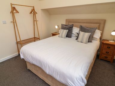 A bedroom with a bed and bedside tables at James Ville Marina Lodge 14, Brigg